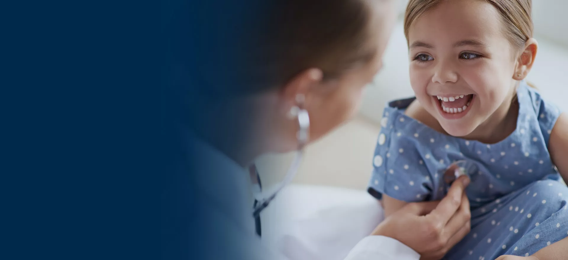 little girl smiling at doctor